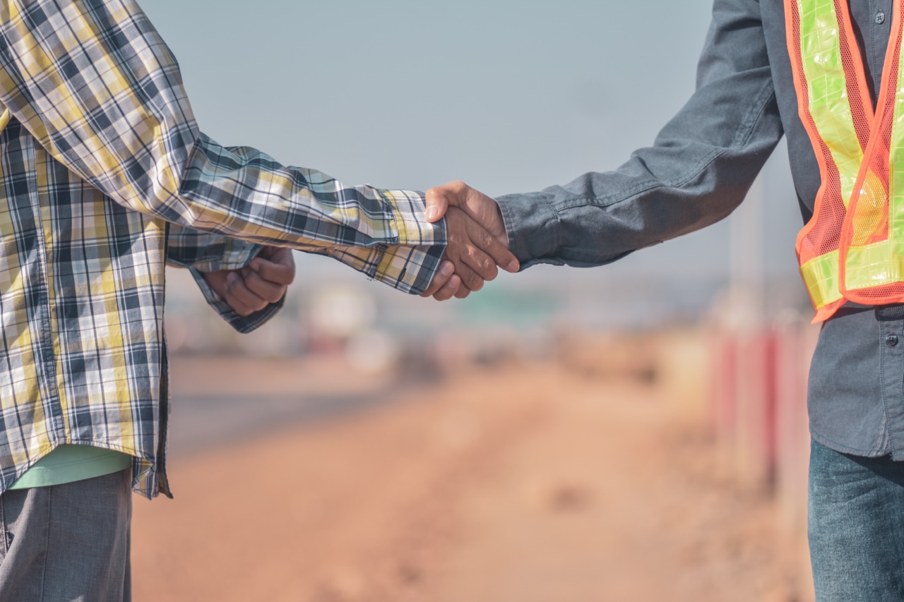 Two people shaking hands at an installation site